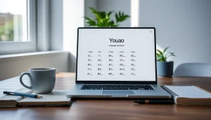 Youdao app displayed on a modern workspace laptop with coffee and notes.